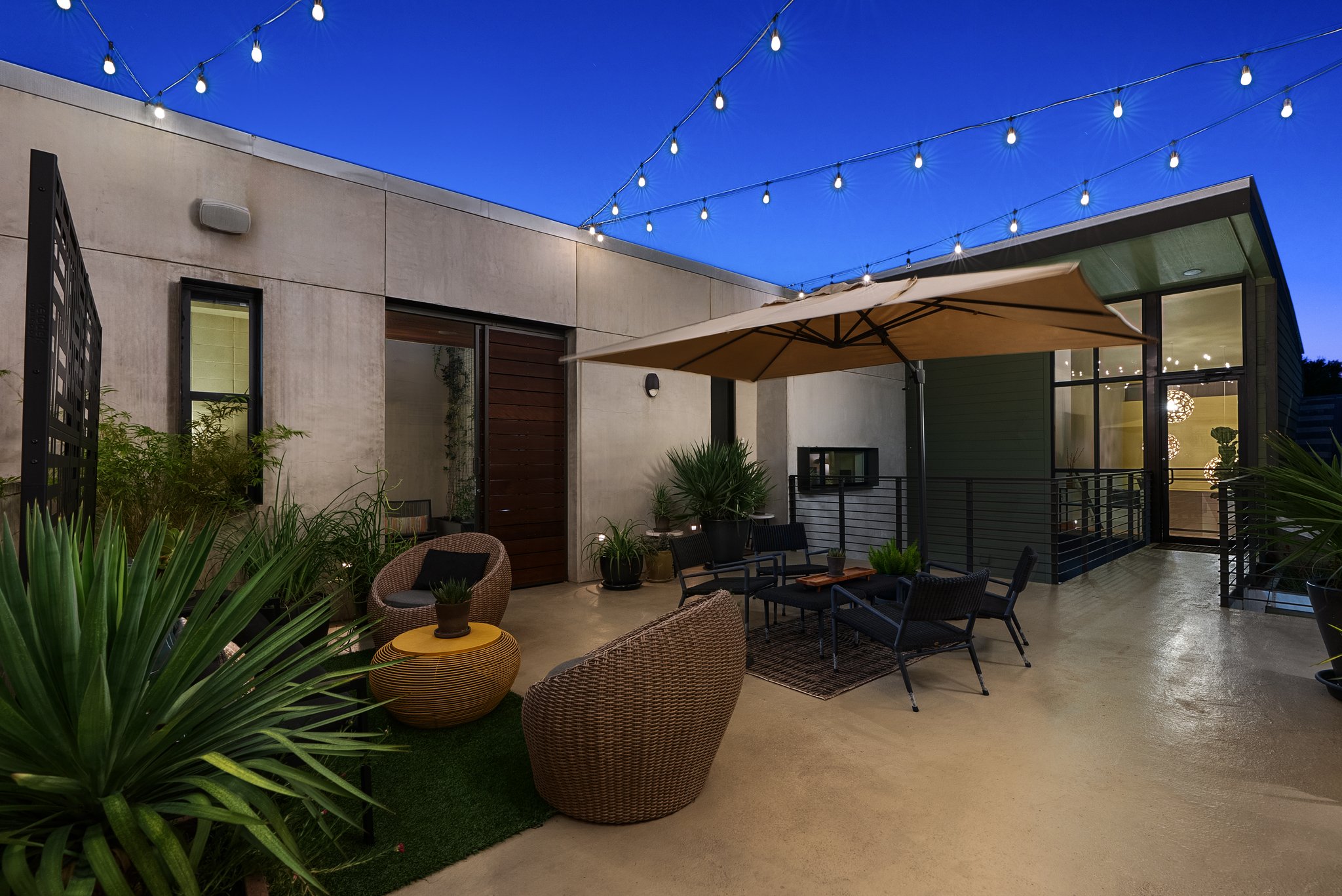 Heywood Hotel's private courtyard patio at night.