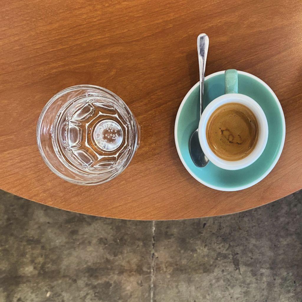 A glass of water next to a shot of espresso at Figure 8 Coffee Purveyor's, one of the Heywood Hotel's favorite East Austin coffee shops.